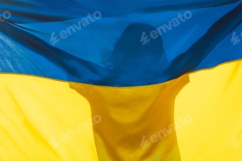 Preview: Woman holding a yellow and blue flag of Ukraine in outdoors. Independence Day.