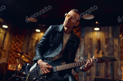 Preview: Brutal guitarist with electric guitar on stage
