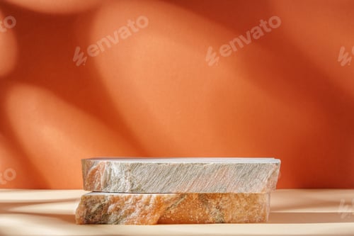 Preview: Piece of granite stone against beige background with shadows