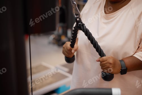 Preview: Woman Exercising with Cable Machine at Fitness Center