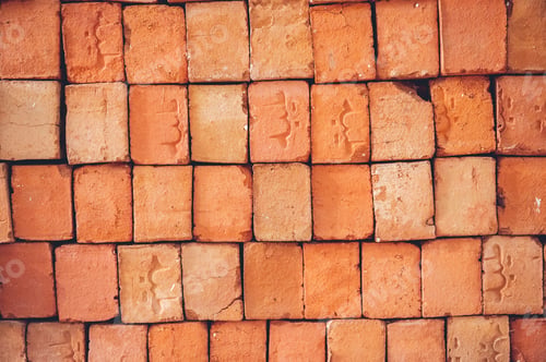 Preview: Closeup of stacked red clay handmade bricks