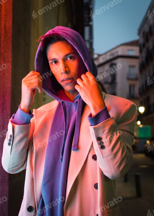 Preview: Young millennial hispanic man with red neon light reflection