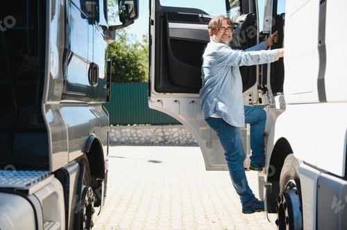 Preview: Portrait of bearded trucker standing by his truck vehicle. Transportation service. Truck driver job