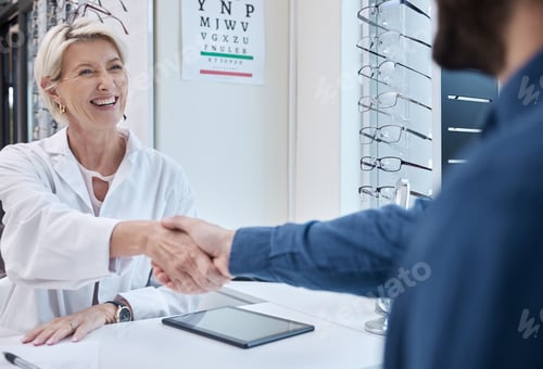 Preview: Senior doctor, handshake or man consulting for eyesight advice at optometrist or ophthalmologist wi