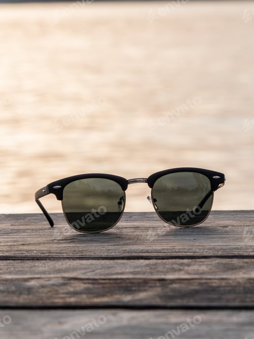Preview: Vertical closeup shot of sunglasses on a wooden ground