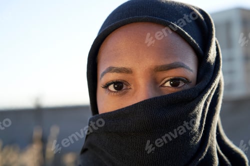 Preview: Close-up of face of a young Muslim girl with hijab looking at the camera.