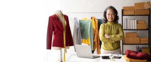 Preview: Portrait of beautiful senior adult selling her clothes online, making a small business in her room,