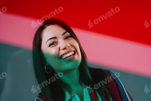 Preview: Smiling woman posing against vibrant colorful background
