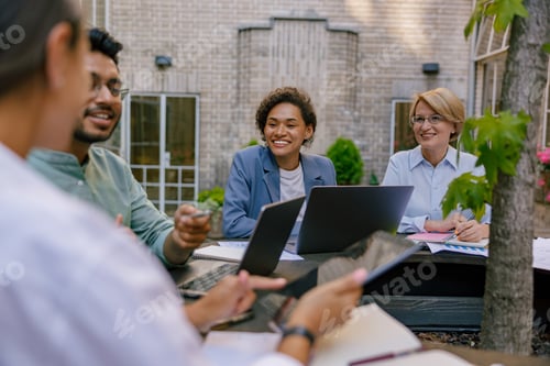 Preview: Group of office workers working on the terrace of the office. Teamwork concept . High quality photo