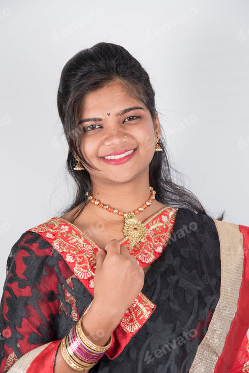 Preview: Happy young beautiful traditional Indian girl in saree