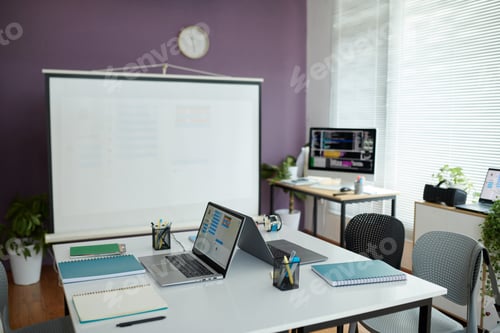 Preview: Modern Office Workspace with Presentation Screen and Laptops