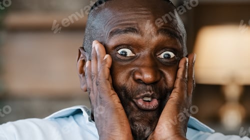 Preview: Surprised portrait african american ethnic joyful emotional man businessman 50s male consumer