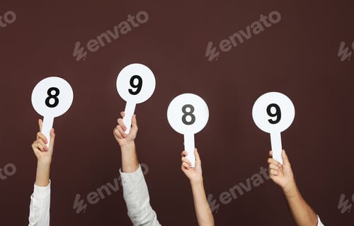 Preview: Panel of judges holding different score signs on brown background, closeup