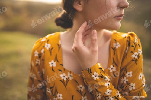 Preview: Beautiful girl walks on the meadow. Photo shoot of a girl in a yellow dress. A walk in the field.