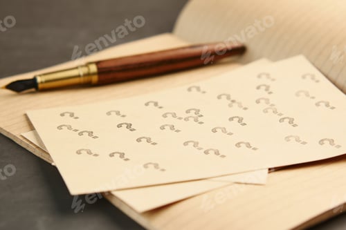 Preview: high angle view of question mark on paper on office desk