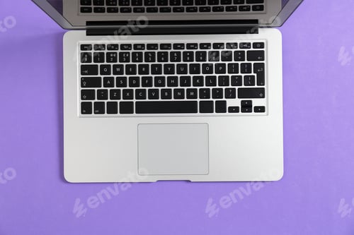 Preview: Modern laptop on color background, top view