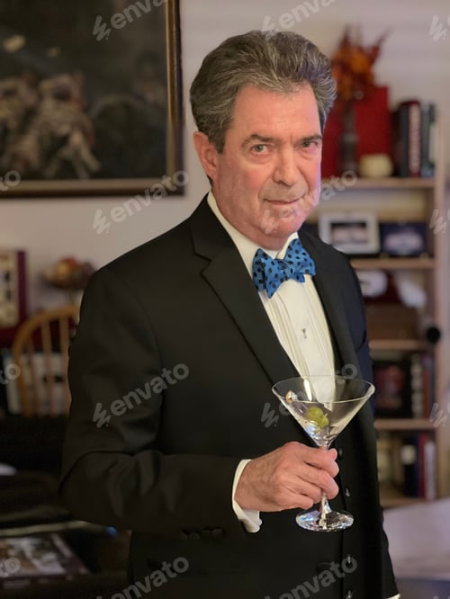 Preview: a man in formal wear holding a martini glass