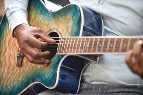 Preview: Unrecognizable young diverse black man musician plays acoustic guitar in local recording studio