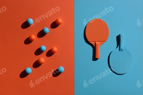 Preview: Top view shot of composition with ping pong rackets and balls placed on two toned surface