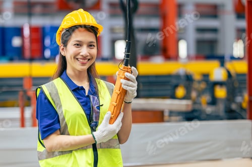 Preview: Young Asian woman engineer worker happy smiling professional working in heavy industry plant factory