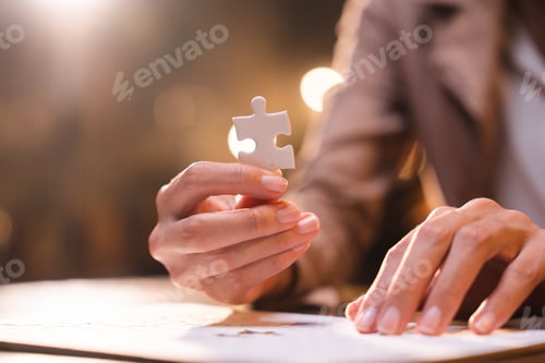 Preview: Business person team work holding jigsaw to connecting successful puzzle piece for matching