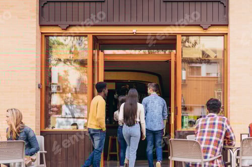 Preview: multiethnic group of friends arriving at a tavern for lunch