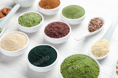 Preview: Different superfood powders on white wooden table, closeup