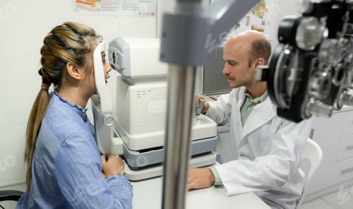 Preview: A young woman checks her eyes with an optometrist.