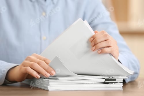 Preview: Woman working with documents at table in office, closeup