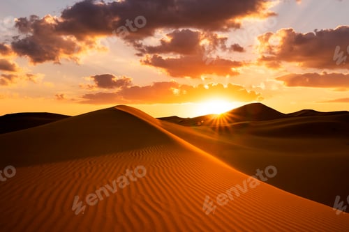 Preview: Sunset over the sand dunes in the desert. Arid landscape of the Sahara desert.