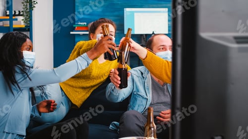 Preview: Mixed races people watching tv clinking bottles of beer enjoying time