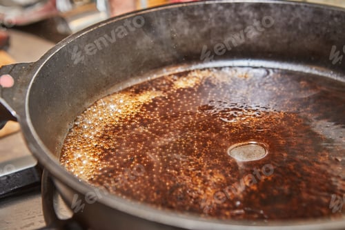 Preview: Caramelized syrup in frying pan on gas stove