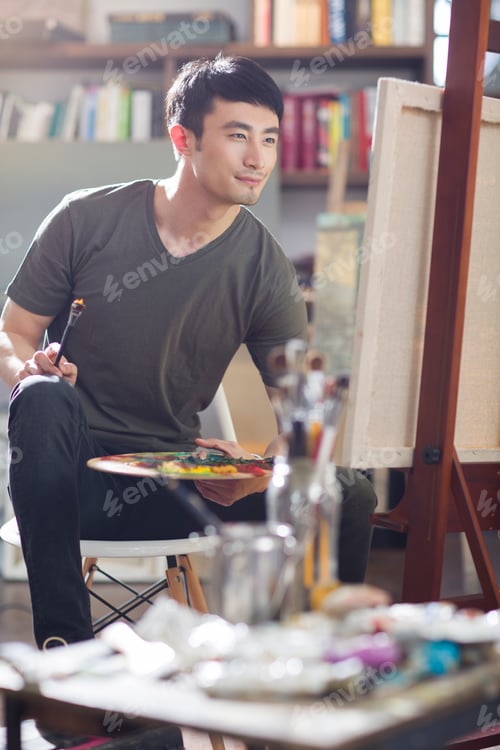 Preview: Artist painting in his studio