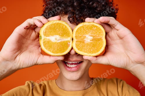 Preview: guy with curly hair oranges near face emotions close-up