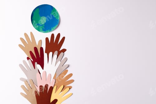 Preview: Paper cut out of multi coloured hands with globe and copy space on white background