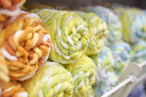 Preview: Rolled colorful towels displayed in store shelf for home and bath decor