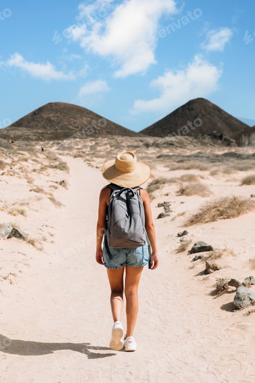 Preview: Traveler walking along mountain road