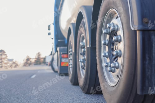 Preview: Industrial cargo transportation. Close-up of rear wheel of truck, rear view with space for text