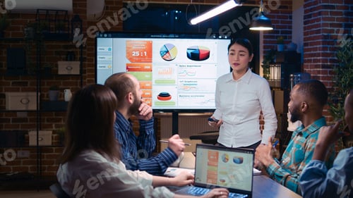 Preview: Team working on company revenue statistics presentation in meeting