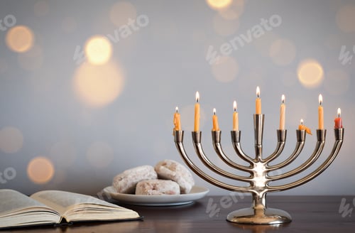 Preview: Chanukah Menorah with nine lit candles open Torah book and jelly filled donuts sufganiyot