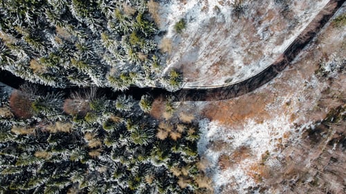 Preview: Snowy landscape with winding mountain road, view from above.