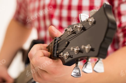 Preview: Music, close-up. Musician holding a wooden guitar