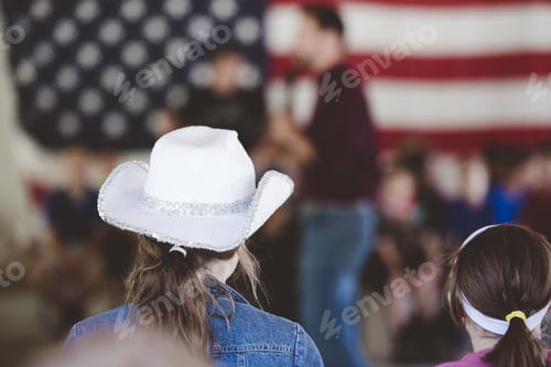 Preview: Shallow focused shot from behind of a female wearing a white cowboy hat