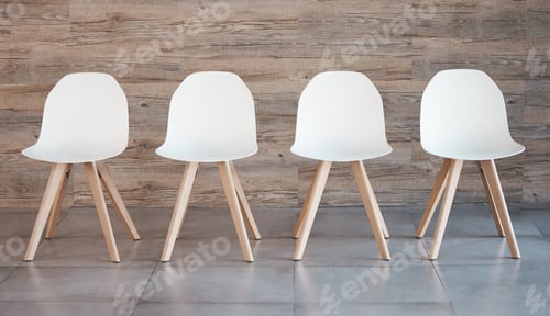 Preview: Hiring staff recruitment drive, interview waiting room and four white office chairs in empty wood w
