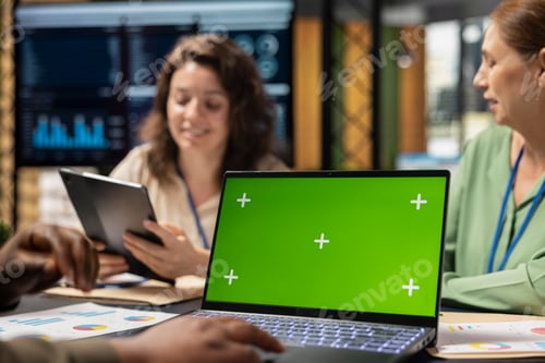 Preview: Determined diverse corporate team using laptop with chroma key