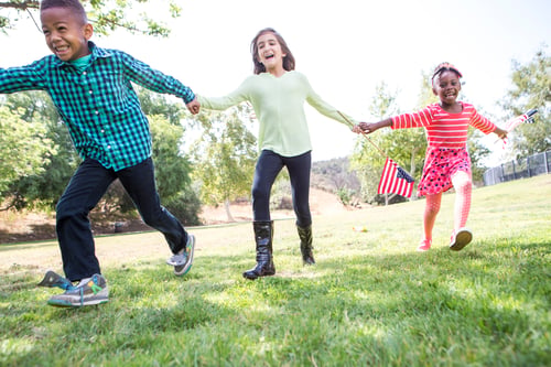 Preview: Children playing with American flag in park