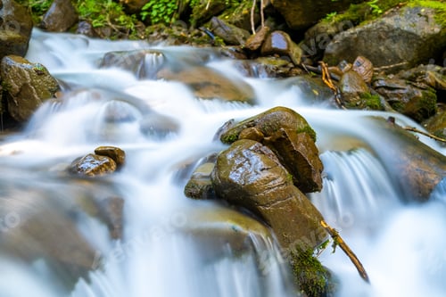 Preview: Mountain river with small waterfall with clear turquoise water falling down