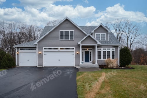 Preview: Gray-walled suburban house with white asphalt driveway