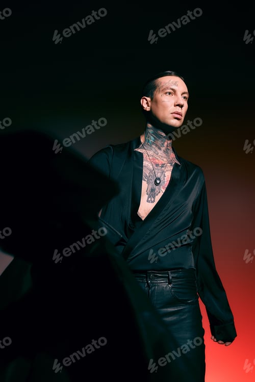 Preview: Stylish young adult man exudes confidence in elegant fashion during dramatic lighting display