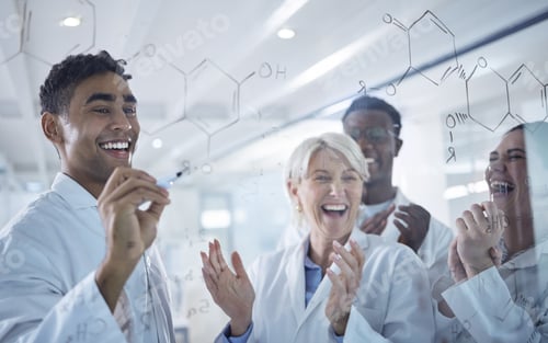 Preview: Diverse group of happy scientists clapping hands while writing and planning together on a board at